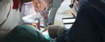 Periodontist performing surgical periodontics treatment