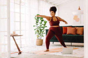 Woman practicing yoga in her living room